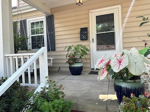 Front porch with beautiful flowers and a porch swing to enjoy the neighborhood