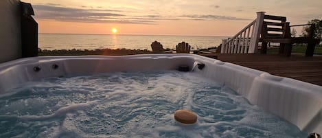 Soak in the sunset while relaxing in our hot tub overlooking Lake Michigan!