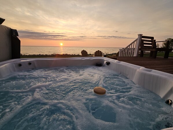 Soak in the sunset while relaxing in our hot tub overlooking Lake Michigan!