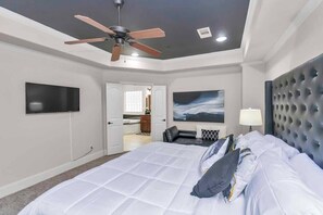 Unit 127-Bedroom #3-Private master suite features a king size bed, 12-foot vaulted ceilings, and a plush chaise lounge. 