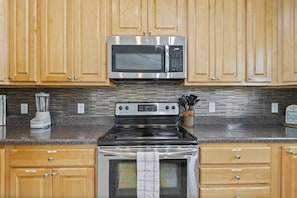 Kitchen with microwave, stovetop and oven