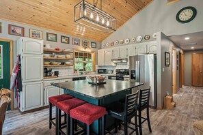 Expansive soapstone island seats 5 and is great for meal prep too.