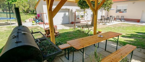 Plant, Property, Table, Wood, Shade, Botany, Outdoor Furniture, Tree, Building, Grass