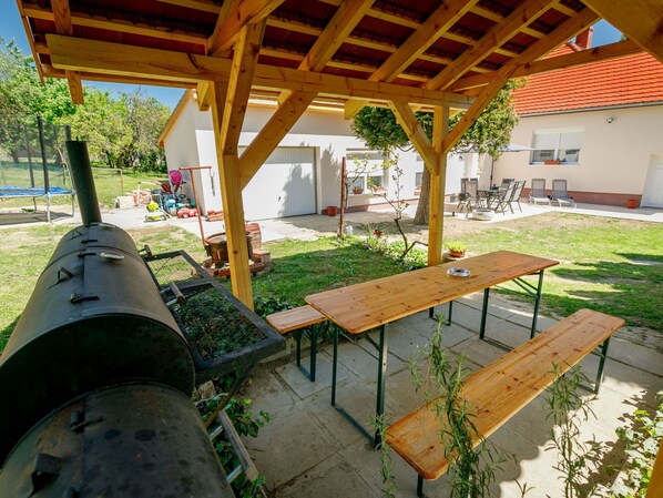 Plant, Property, Table, Wood, Shade, Botany, Outdoor Furniture, Tree, Building, Grass