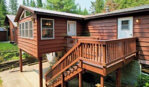 Deck from sunroom leading to covered patio.