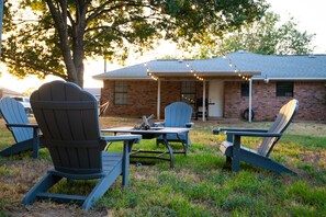 Outdoor fire pit with string lights for a perfect cookout.