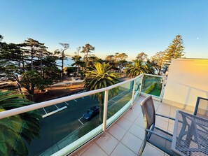 Sunset balcony view overlooking beach and parkland