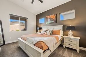Primary bedroom with king bed, smart TV, attached bath, and large closet.