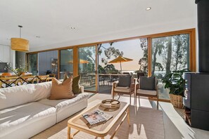 Huge sliding doors cascade across the front of the home.