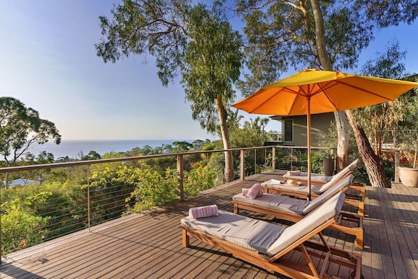 Four, large sun chairs line the huge balcony.