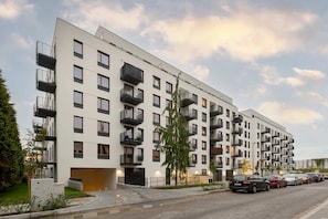 An exterior view of the residential building, highlighting its contemporary architecture and clean surroundings.