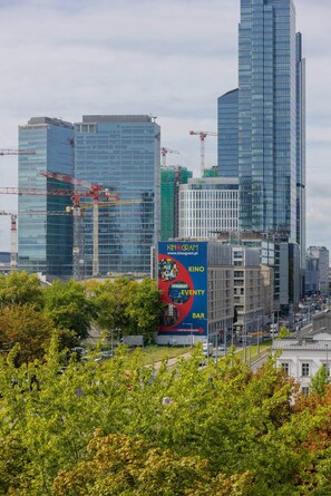 A city view. Lush greenery adds contrast to the urban background.
