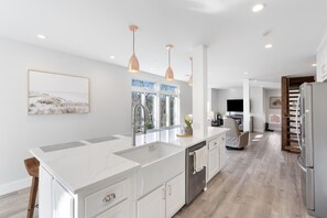 Large Island with Seating for Six. Our kitchen is stocked with all the conveniences of home.