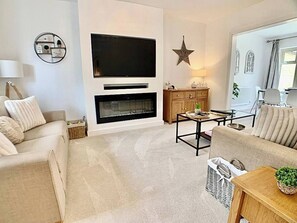 Bright lounge with newly built media wall, Smart 55" TV with Sky and access to Netflix. Sound bar and cosy electric fire, Amazon Alexa Bluetooth speaker. New carpets and furniture.