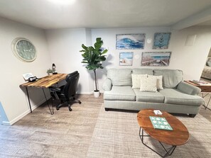 living room space with a queen sofa sleeper, and desk area (we offer free WiFi)