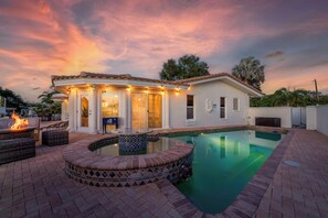 Outdoor Oasis: Unwind by the sparkling pool, surrounded by vibrant sunset views and fire pit charm!