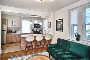 Spacious Living Room with Large Sofa, Coffee Table, and 55" HD Smart TV. 