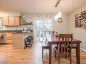 Well-equipped kitchen and dining area with an access to the back deck.