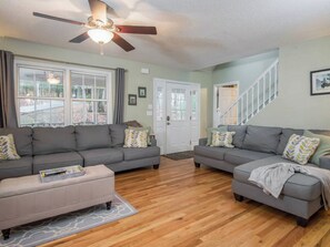 Relax and entertain in this spacious living room with ample seating for all.