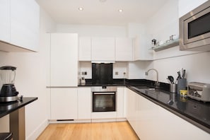 Fully equipped kitchen with modern cooking appliances.