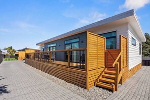 Front deck fully fenced, outdoor furniture with umbrella, Weber barbeque