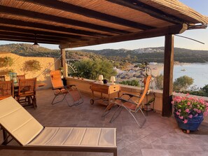 Beachfront patio with dining area and sunbeds