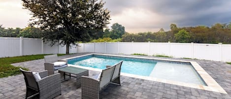 Lounge by your very own private pool in the spacious fenced back yard