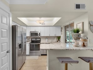 Fully Stocked Open Kitchen with Stainless Steel Appliances