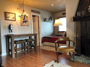 Small rustic dining table with ample space and stools