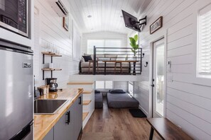 The kitchen is fully equipped with a refrigerator, freezer, microwave, cook-top and sink with hot/cold water. Enjoy coffee from the coffee maker, and find ample counter space, cookware, and storage for all your meal prep needs.