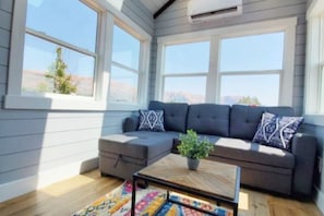Relax in the inviting living room featuring a comfortable couch, and a TV for entertainment. A sofa bed provides extra sleeping space, and with Wi-Fi access, this space is perfect for unwinding or enjoying your favorite shows and movies.