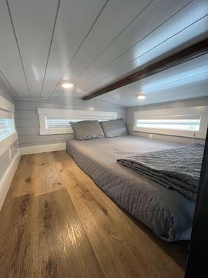 Enjoy a restful night on a comfortable queen-sized bed with soft, crisp linens. The plush mattress provides the perfect balance of support and comfort, ensuring you wake up feeling refreshed and ready to take on the day.