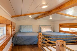 Enjoy a restful night on two comfortable single-sized beds with soft, crisp linens. The plush mattress provides the perfect balance of support and comfort, ensuring you wake up feeling refreshed and ready to take on the day.