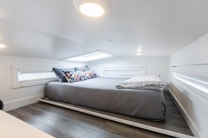 Enjoy a restful night on a comfortable queen-sized bed with soft, crisp linens. The plush mattress provides the perfect balance of support and comfort, ensuring you wake up feeling refreshed and ready to take on the day.