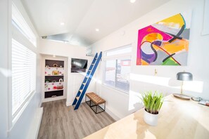 Relax in the inviting living room featuring a comfortable couch/sofa bed and a large TV for entertainment. Stay connected with Wi-Fi access, making this space perfect for unwinding or enjoying your favorite shows and movies.