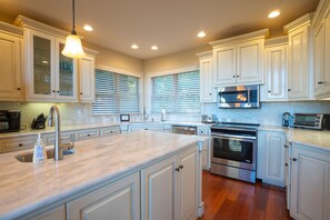 Beautiful kitchen fully stocked with plenty of pot, pans and other cookware