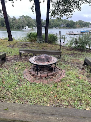 Fire pit with 4 benches and plenty of available wood on site.