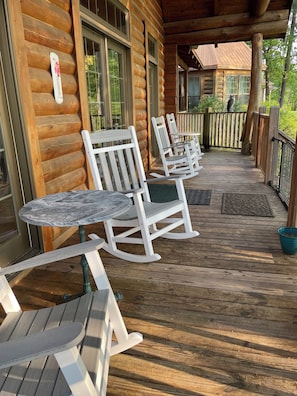 Back Deck overlooks waterfront, has rocking chairs, tables, rope chair swings