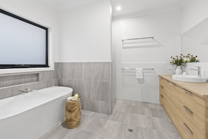Ensuite to Master Bedroom 1 with walk in shower with rain head, bath, large vanity and toilet