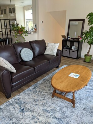 Very comfortable couch in the living room, facing its huge TV!