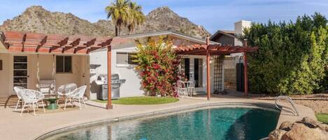 Lush backyard with Piestewa Peak views, misters, outdoor dining and private pool