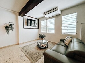 Our elegantly designed living room is the perfect escape, with AC ensuring a refreshing ambiance year-round