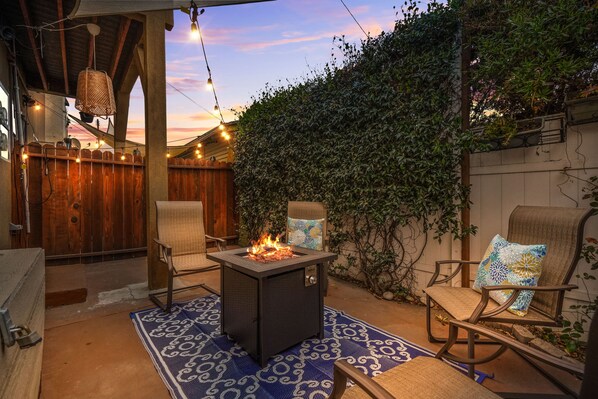 Cozy Patio with Fire Pit and String Lights