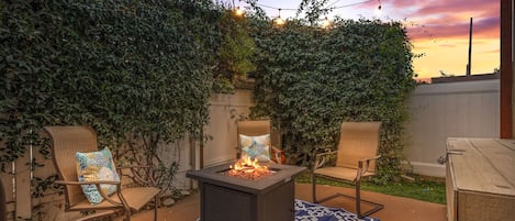 Cozy Patio with Fire Pit and String Lights
