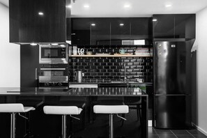 Step into a contemporary fully equipped kitchen, complete with modern appliances and stylish finishes that make cooking and entertaining a breeze.