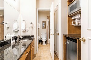 Primary Bathroom with Microwave, Mini Fridge, and Coffee Maker + Bathtub/Shower Combo
