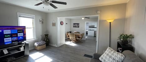 View from living room into dining and kitchen; 58” smart tv; complimentary wi-if