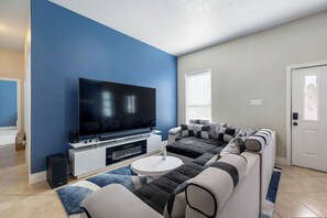 Living Room with 85" Samsung 4K TV, Dolby Atmos Surround Sound, and Fireplace