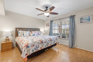Primary Bedroom - King Bed, Patio Access, Pool + Canal Views
