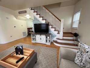 Living Room Area featuring Spacious Sectional Couch & Smart TV